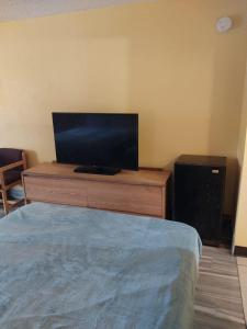 a bedroom with a bed and a flat screen tv at Gated 2 Queen Beds Hotel Room 257 in Jackson