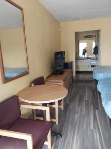a small room with a table and a bed at Gated 2 Queen Beds Hotel Room 257 in Jackson