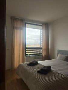a bedroom with a bed with two towels on it at Sasha Yo in Razlog