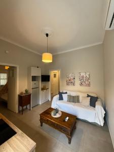 a bedroom with a bed and a table in it at The Garden House in Tinos