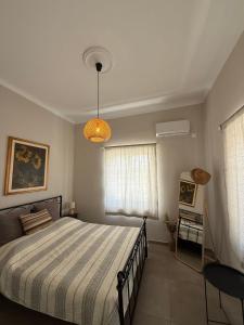 a bedroom with a large bed and a window at The Garden House in Tinos