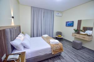 a hotel room with a bed and a desk at Hôtel Atlas in Tangier