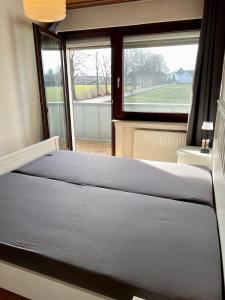 a bedroom with two beds in front of a window at Haus in Kamen Nähe Sportschule in Kamen