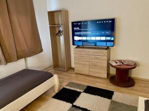 a bedroom with a flat screen tv and a bed at Haus in Kamen Nähe Sportschule in Kamen