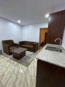 a living room with a couch and a table at House 2 Guest House - Felele in Ibadan +13 photos