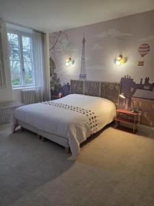 a bedroom with a large bed with a tower on the wall at Bégous in Valderiès +31 photos