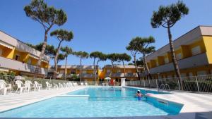 a person in a swimming pool at a resort at Piazzetta 293 in Rosolina Mare +2 photos