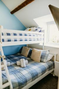 a bedroom with bunk beds in a attic at Pauls Place in Brynsiencyn