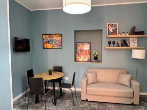 a living room with a couch and a table at Living Room Orlando in Corigliano Calabro