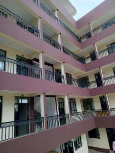 an exterior view of a building with pink balconies at Wema m stays in Munyu