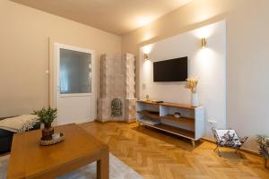 a living room with a television on a wall at Schiller Apartment - Old Town in Sibiu