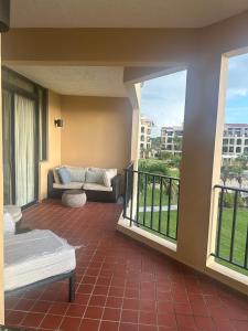 a balcony with a couch and a couch on a patio at Mediterranean Caribbean View Village in Buena Vista