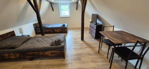 a bedroom with a bed and a desk and a table at Ferien- & Monteurwohnung Stößen in Stößen