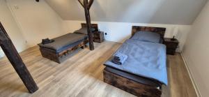 a attic room with two beds in a room at Ferien- & Monteurwohnung Stößen in Stößen