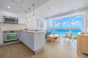 a kitchen with a view of the ocean at Glamorous and modern beach apartment Eagle beach ARUBA in Savaneta