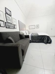 a living room with a couch and a bed at Marinella House Napoli centro Piazza Dante in Naples