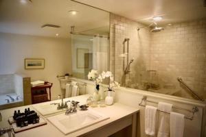 a bathroom with a sink and a large mirror at The Little Inn in Bayfield +54 photos