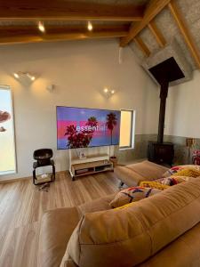 a living room with two beds and a large screen tv at Laina Kai in Sumoto