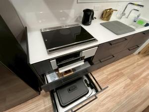 a kitchen counter with a tv on top of it at Laina Kai in Sumoto