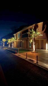 a building with a palm tree in front of a street at Laina Kai in Sumoto