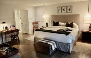 a large bedroom with a large bed and a desk at The Little Inn in Bayfield