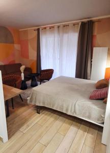 a bedroom with a bed and a table and chairs at Le "BonLieu" - Annecy Lac & Centre Ville in Annecy