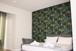 a bedroom with a large bed with a floral wallpaper at Palazzo Partenope in San Severo