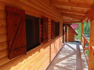 a cabin with a window on the side of it at Wildas Cabins, Tara River Canyon in Foča +49 photos
