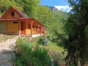 a wooden cabin in the middle of a forest at Wildas Cabins, Tara River Canyon in Foča