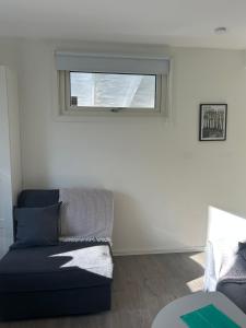 a living room with a couch and a window at Tunneberga 1 65 in Jonstorp