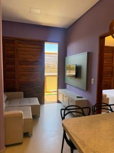a room with two beds and a large window at Casa Floratta - Flecheiras in Flecheiras
