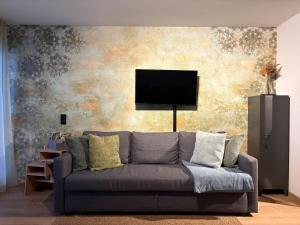 a living room with a couch and a flat screen tv at AuszeitOase inkl Oberstaufen Plus Karte in Oberstaufen