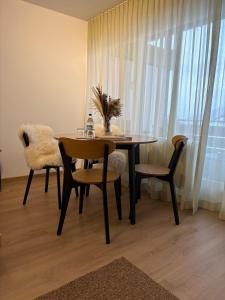 a dining room with a table and chairs and a window at AuszeitOase inkl Oberstaufen Plus Karte in Oberstaufen +7 photos