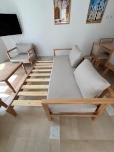 a living room with a bed and a tv at Dar Lisa - Charming authentic beachfront villa in Aghīr +54 photos