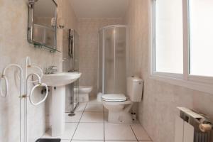 a bathroom with a toilet and a sink and a shower at La Zinca in Cambre +29 photos