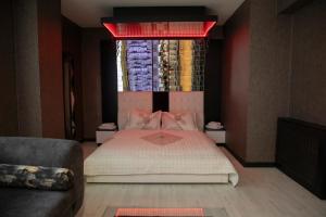 a bedroom with a large bed and a window at Hera Suit Ataşehir in Istanbul