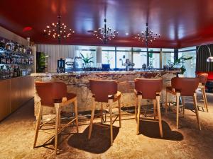 a bar with chairs and a counter in a room at La Licorne Hotel & Spa Troyes - MGallery Collection in Troyes