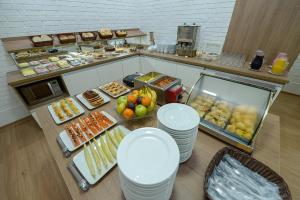 an overhead view of a buffet with many different types of food at Pousada Prime Gramado in Gramado
