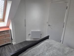 a bedroom with a bed and a dresser at The Fox Apartment LBA in Horsforth