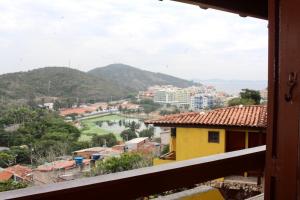 a view of a town with a river and mountains at Suíte Atobás in Arraial do Cabo