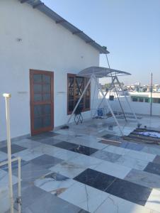 a building with a patio with an umbrella at Leisure Paradise in Kharar +7 photos