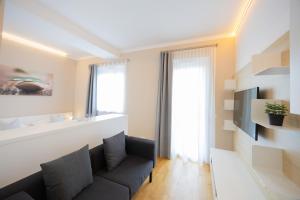 a living room with a couch and a window at SHOME Hotel Graz I Self-Check-In I Free Parking in Graz