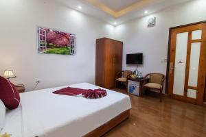 a bedroom with a bed with a red bow on it at Luxury Airport Hotel Travel in Sóc Sơn