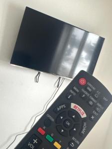 a remote control sitting on top of a table at Your private room CozyVibe in Edmonton