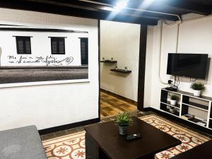 a living room with a tv and a table at MOKA HOUSE in Santo Domingo