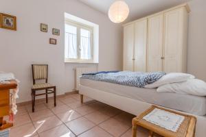 a bedroom with a bed and a chair at Casa Simone in Torella deʼ Lombardi
