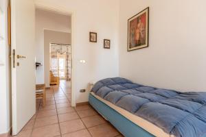a bedroom with a blue bed in a room at Casa Simone in Torella deʼ Lombardi