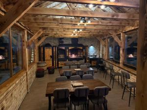 a room with tables and chairs and a fireplace at Koliba Buba in Brčko