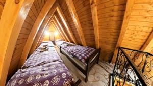 an attic room with two beds and a balcony at Koliba Buba in Brčko +16 photos