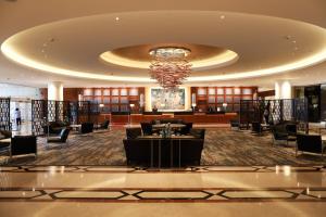 a lobby with a chandelier and tables and chairs at InterContinental David Tel Aviv by IHG in Tel Aviv +146 photos